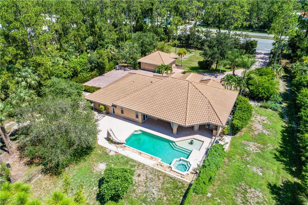 4430 Pine Ridge Road Naples, FL 34119 - Photo 35 of 35 an aerial view of a house with a yard and large trees