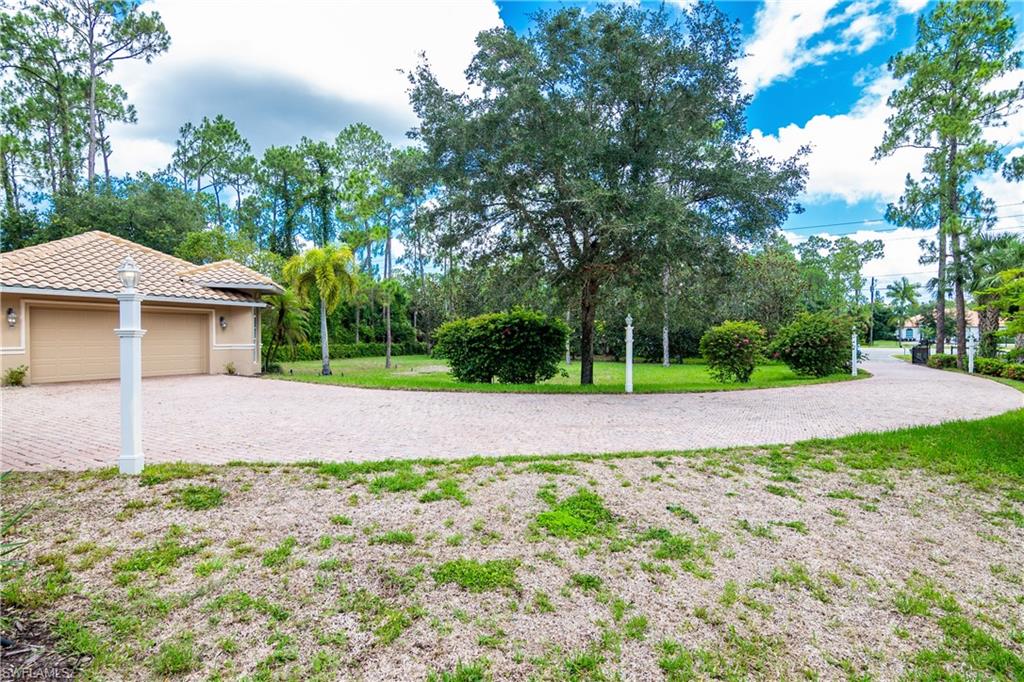 4430 Pine Ridge Road Naples, FL 34119 - Photo 4 of 35 a view of house with backyard and green space