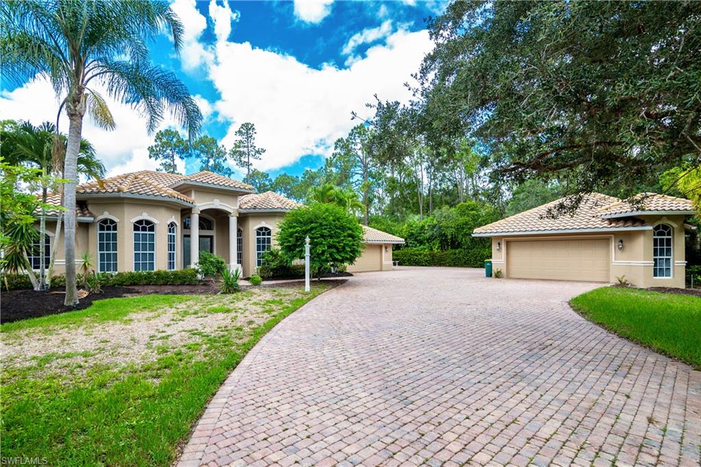 4430 Pine Ridge Road Naples, FL 34119 - Photo 5 of 35 a front view of a house with yard