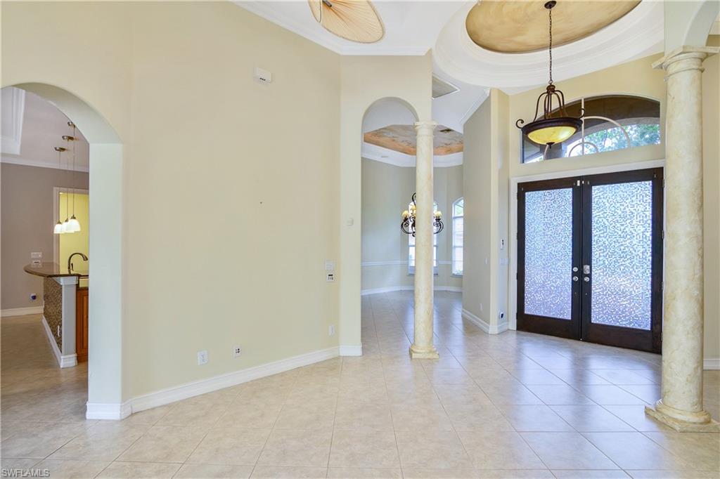 4430 Pine Ridge Road Naples, FL 34119 - Photo 9 of 35 a view of a hallway with a chandelier