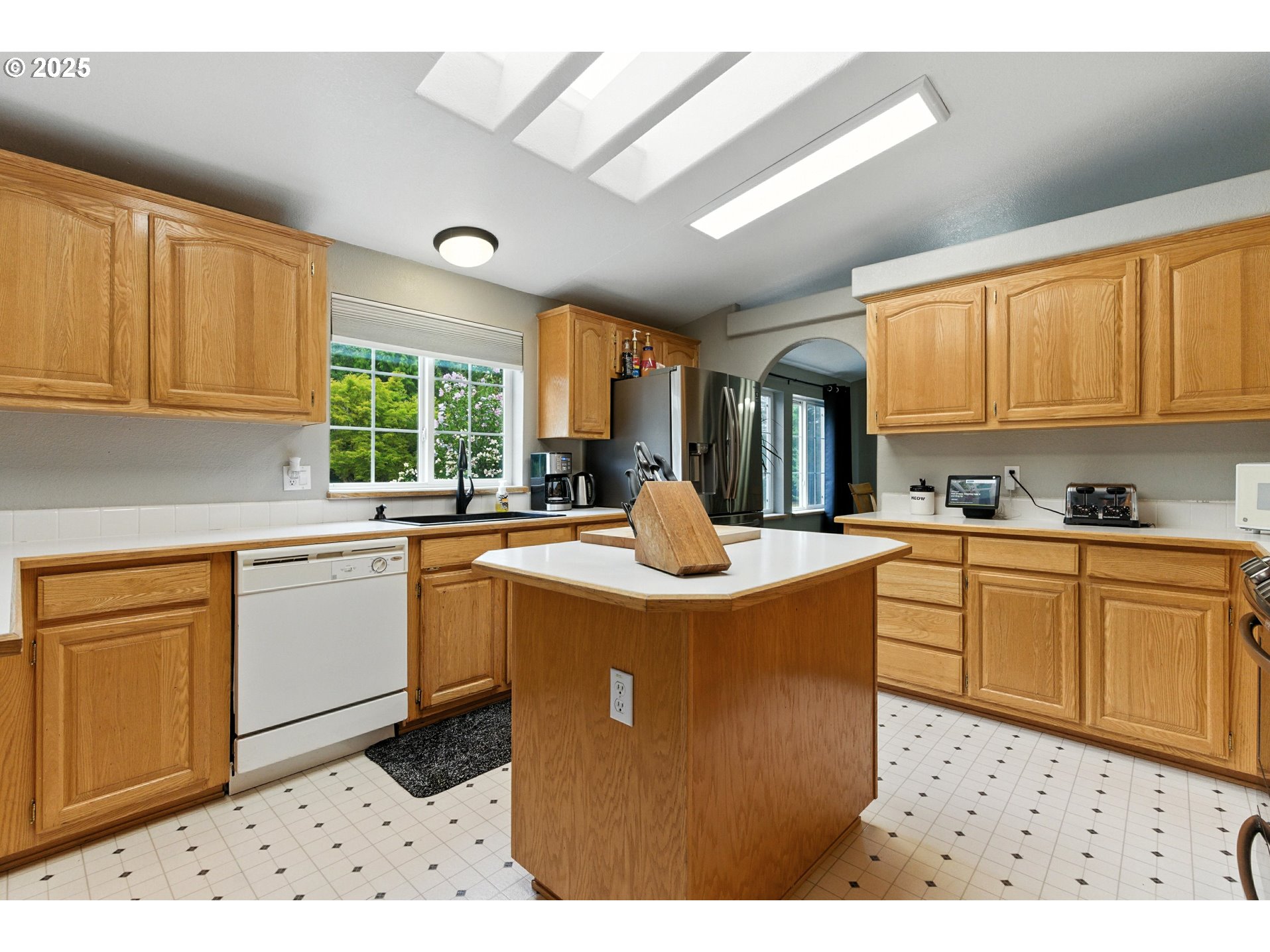 20160 Southeast Foster Road Damascus, OR 97089 - Photo 31 of 48 a kitchen with stainless steel appliances granite countertop a stove a sink dishwasher and a refrigerator