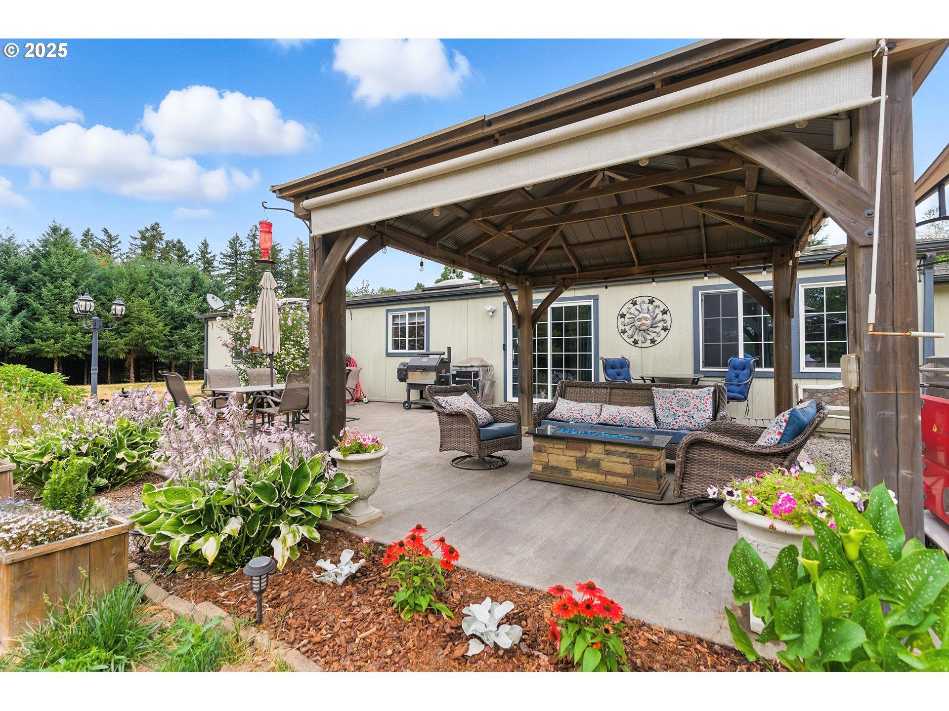 20160 Southeast Foster Road Damascus, OR 97089 - Photo 5 of 48 a view of a patio with table and chairs and potted plants