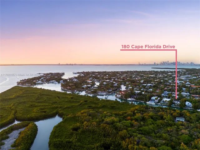 a living room with furniture a chandelier and a dining table