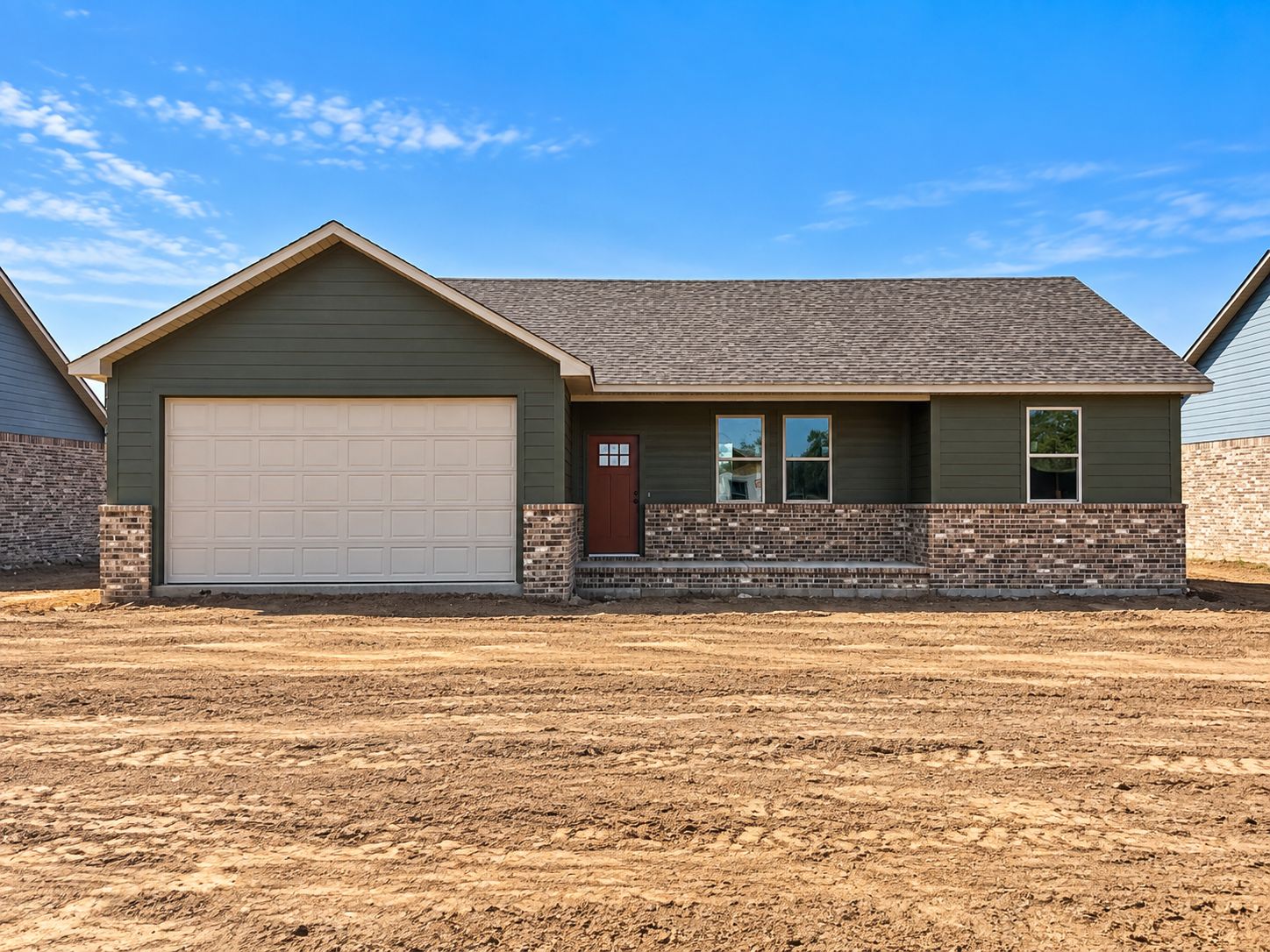 129 Countryside Way Pocola, OK 74902 - Photo 1 of 1 Siding exterior with a brick skirt, covered porch, and an attached garage