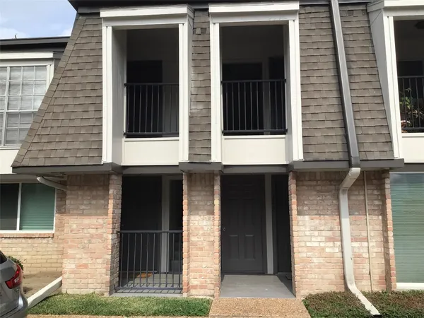a view of a brick house with a large windows