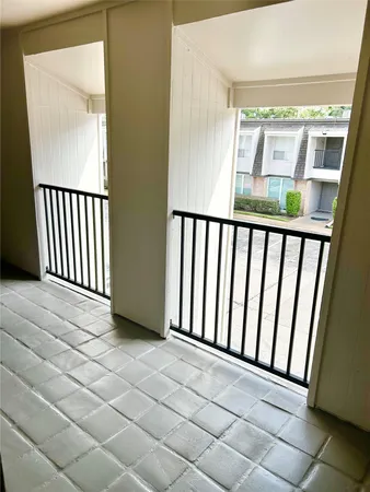 a view of a porch with wooden floor and entrance