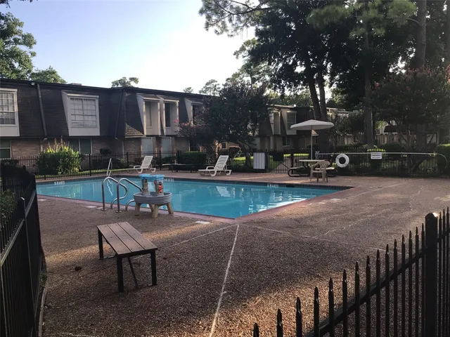a view of a patio with table and chairs and potted plants