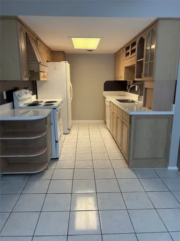 a kitchen with a sink a stove and cabinets