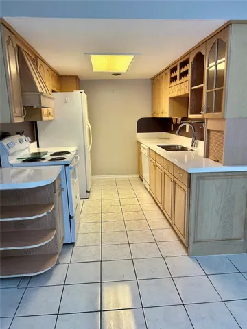 a kitchen with a sink a stove and a microwave