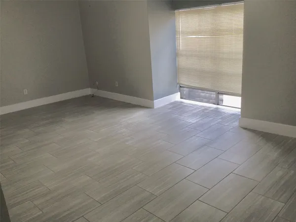an empty room with wooden floor and door