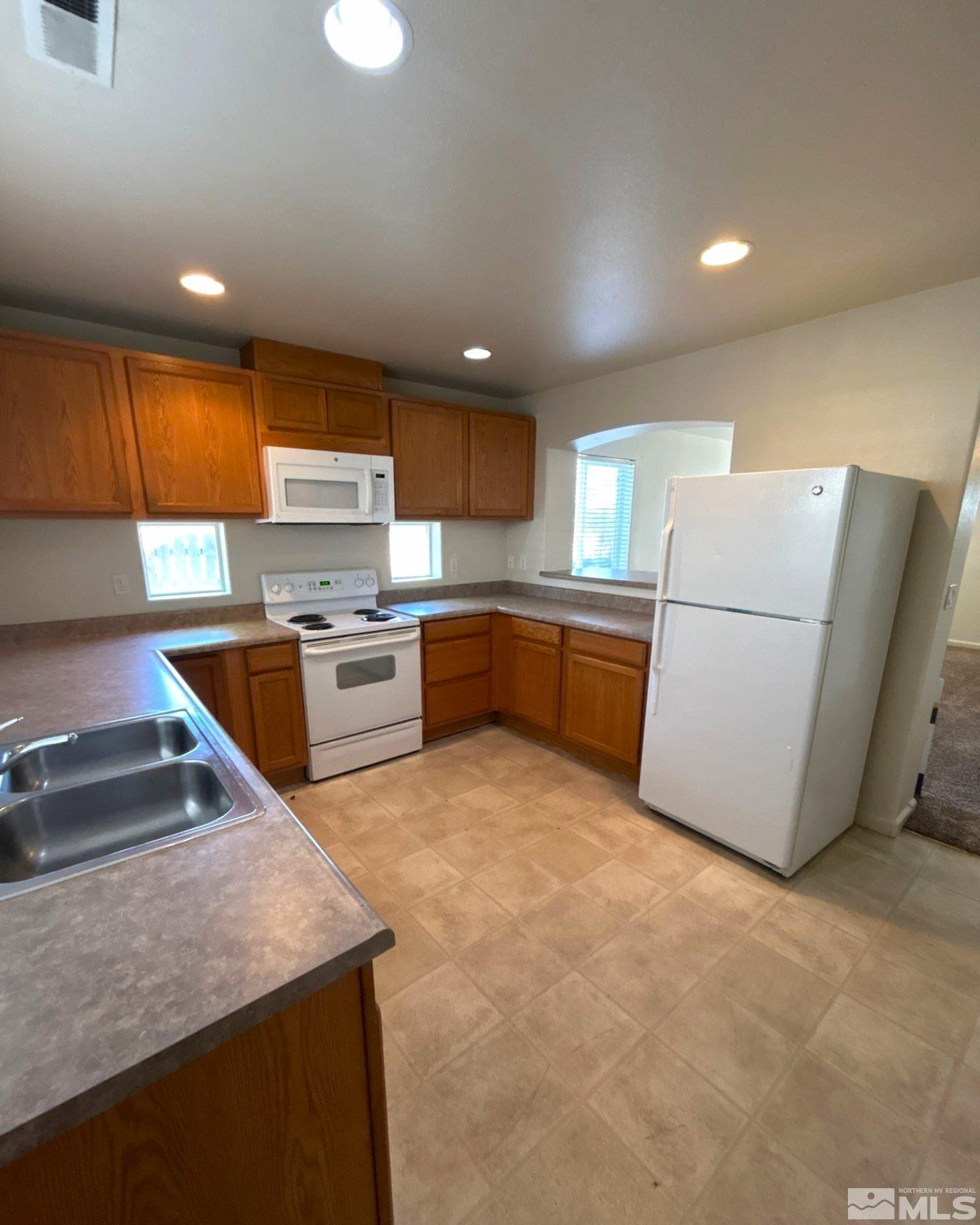 412 10th Street, Unit B Sparks, NV 89431 - Photo 4 of 13 a kitchen with stainless steel appliances granite countertop a sink stove and refrigerator