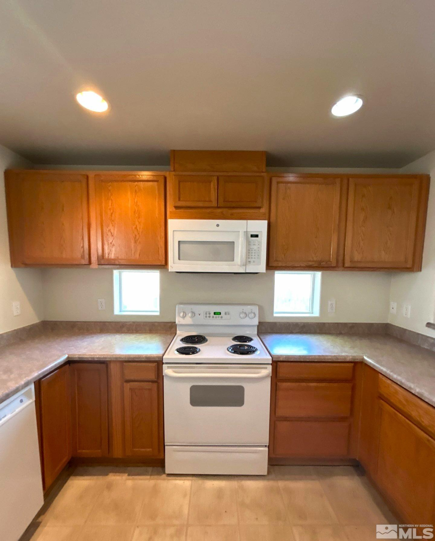412 10th Street, Unit B Sparks, NV 89431 - Photo 5 of 13 a kitchen with white cabinets and white appliances