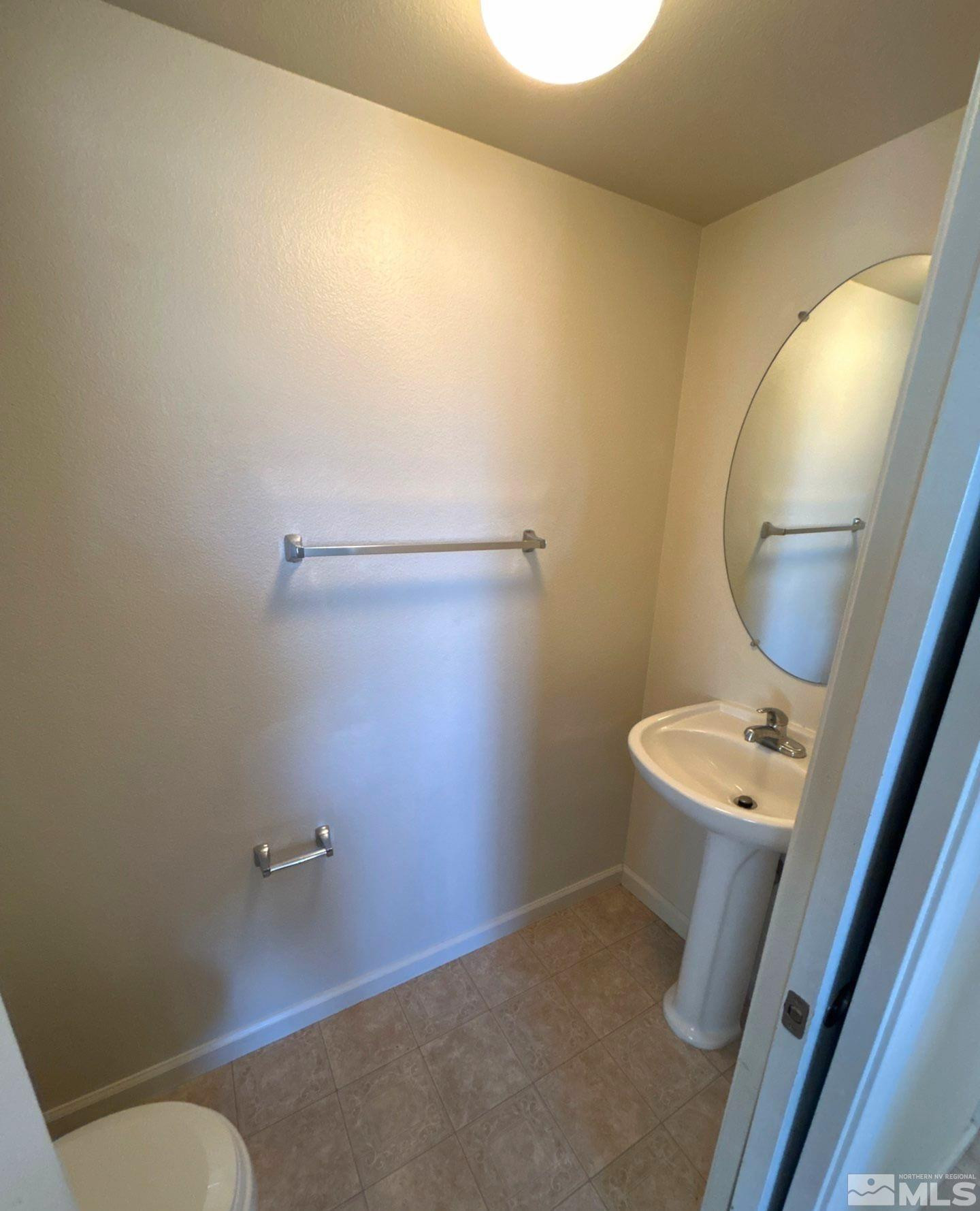 412 10th Street, Unit B Sparks, NV 89431 - Photo 8 of 13 a bathroom with a sink mirror and toilet
