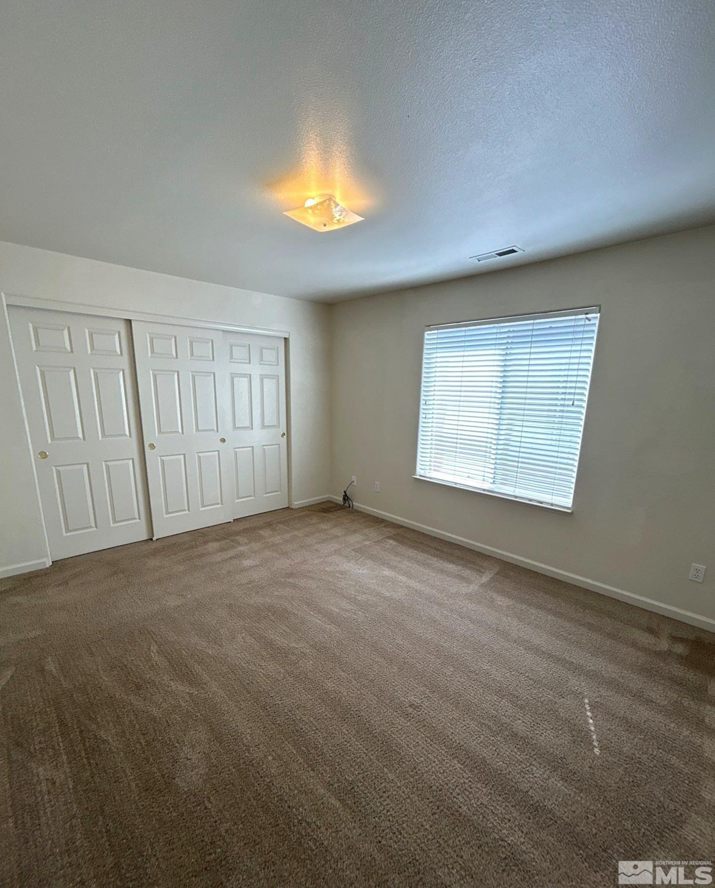 412 10th Street, Unit B Sparks, NV 89431 - Photo 10 of 13 an empty room with windows