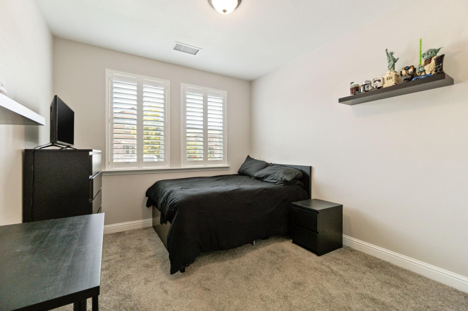 639 Mesa Drive Madera, CA 93636 - Photo 15 of 33 a bedroom with a bed and dresser