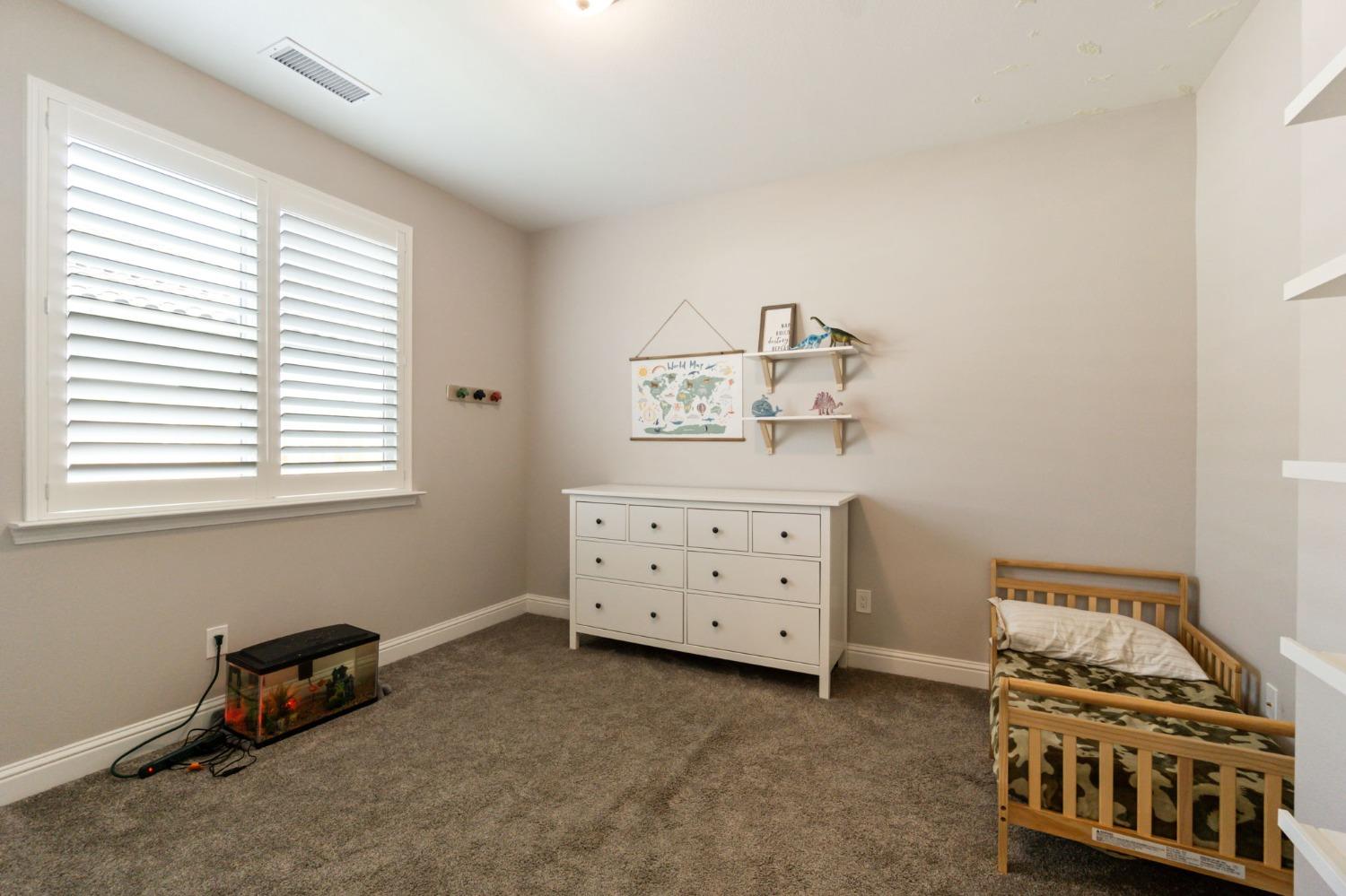 639 Mesa Drive Madera, CA 93636 - Photo 16 of 33 a bedroom with a bed and a dresser