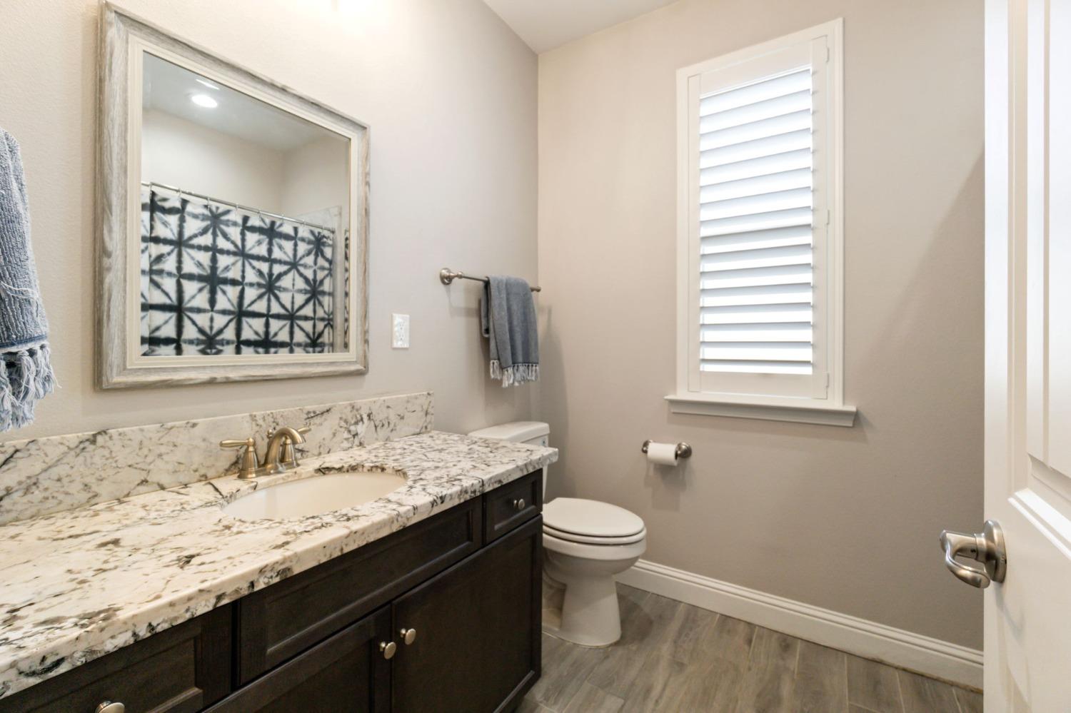 639 Mesa Drive Madera, CA 93636 - Photo 17 of 33 a bathroom with a granite countertop sink toilet and shower