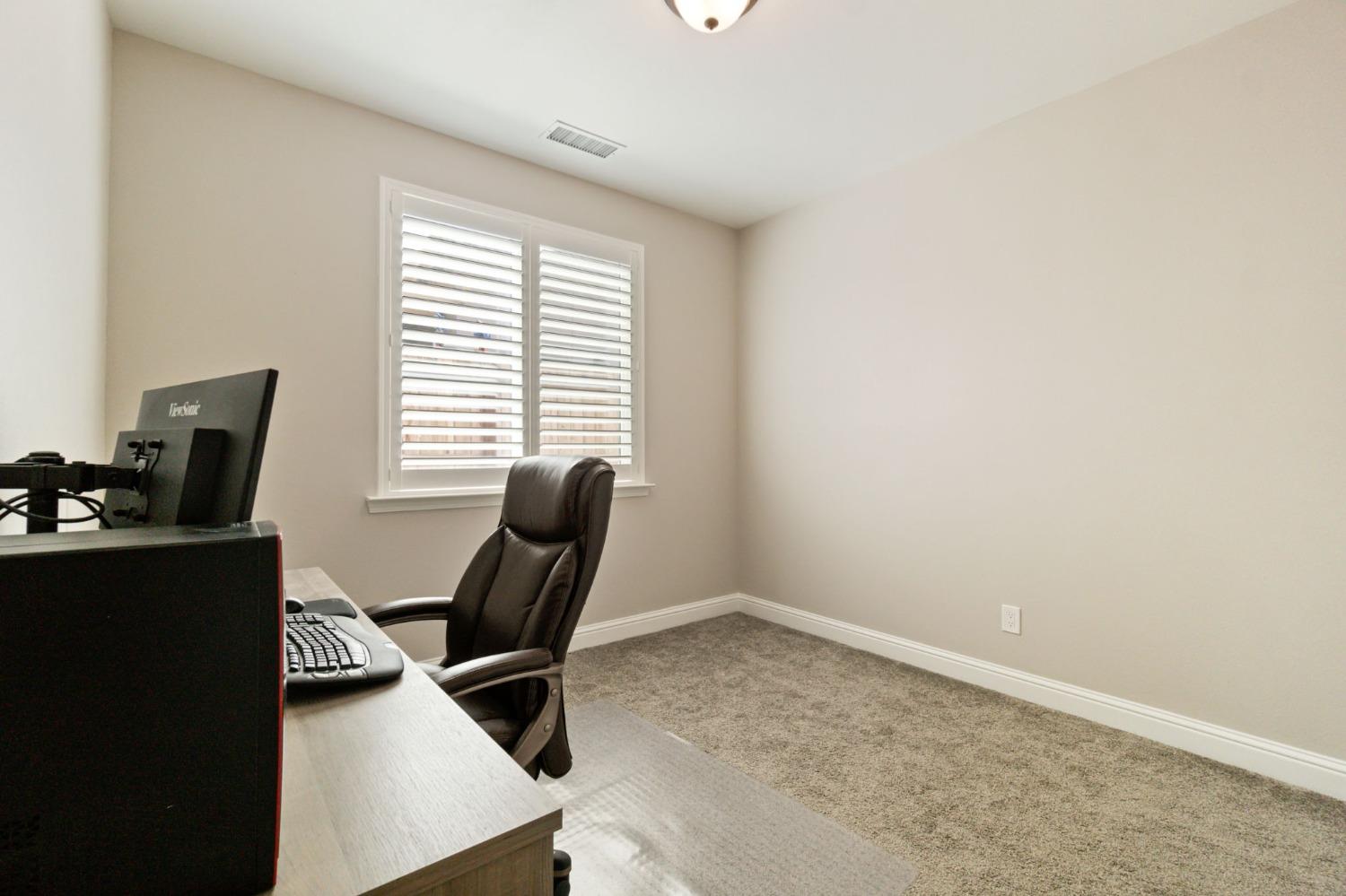 639 Mesa Drive Madera, CA 93636 - Photo 19 of 33 a view of a workspace with furniture and a window