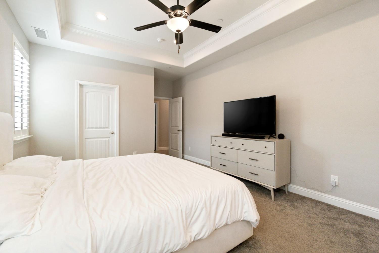 639 Mesa Drive Madera, CA 93636 - Photo 22 of 33 a bedroom with a bed and a flat screen tv
