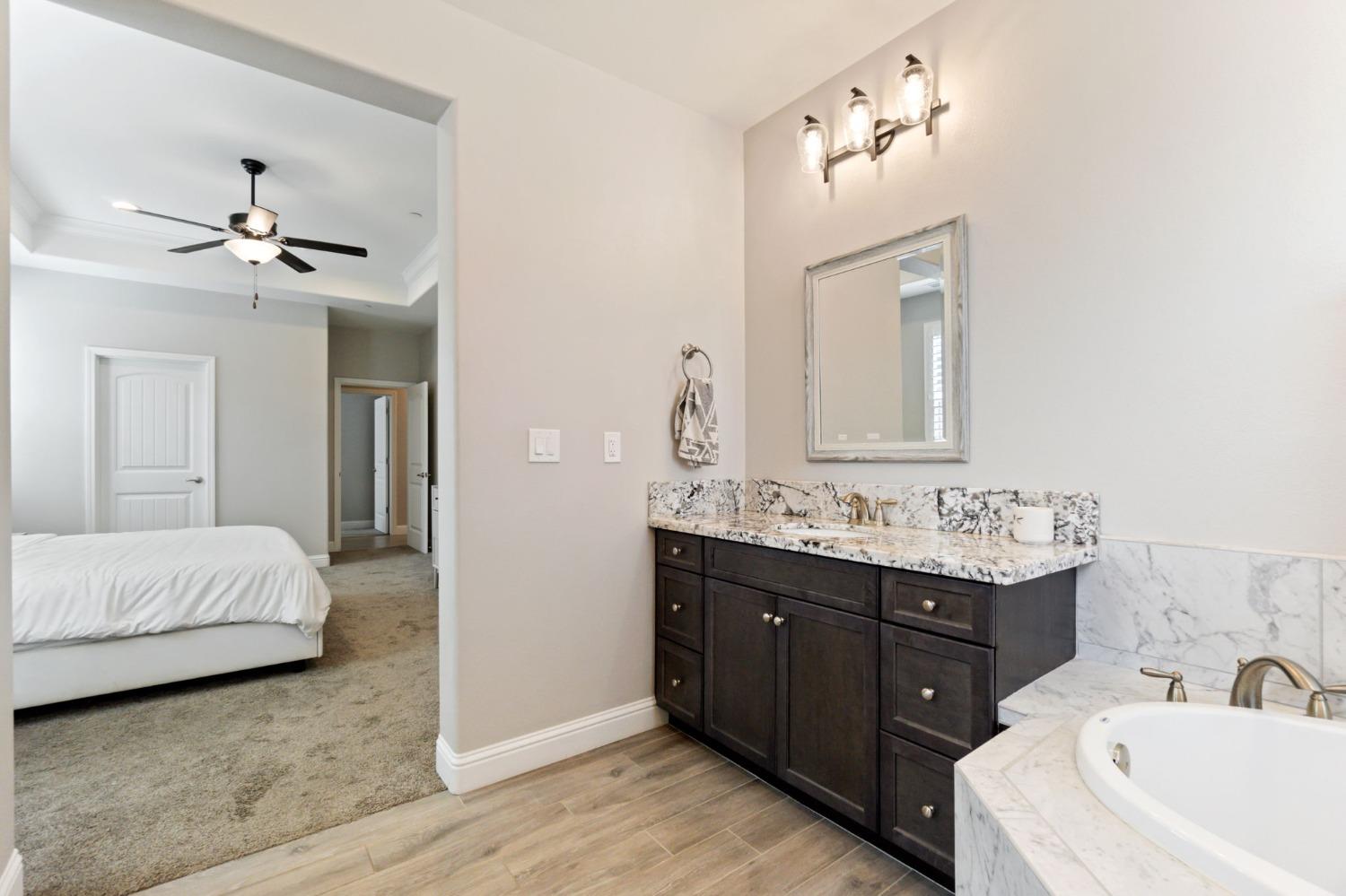 639 Mesa Drive Madera, CA 93636 - Photo 24 of 33 a spacious bathroom with a double vanity sink mirror and bathtub