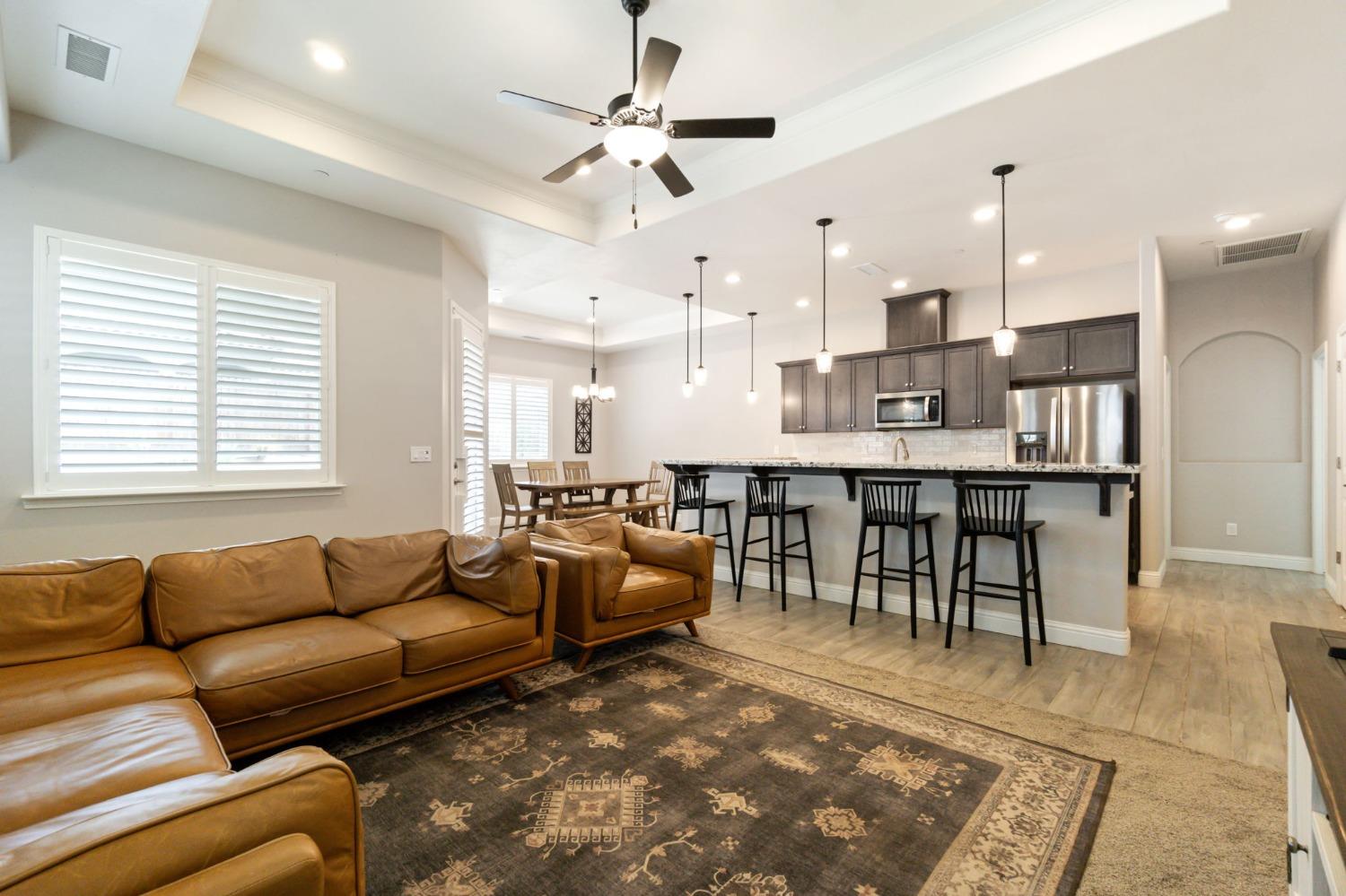 639 Mesa Drive Madera, CA 93636 - Photo 7 of 33 a living room with furniture a dining table and kitchen view