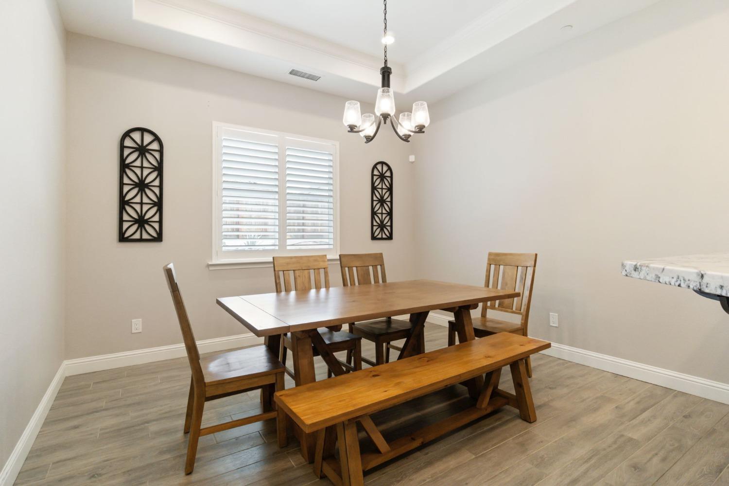 639 Mesa Drive Madera, CA 93636 - Photo 9 of 33 a view of a dining room with furniture window and wooden floor