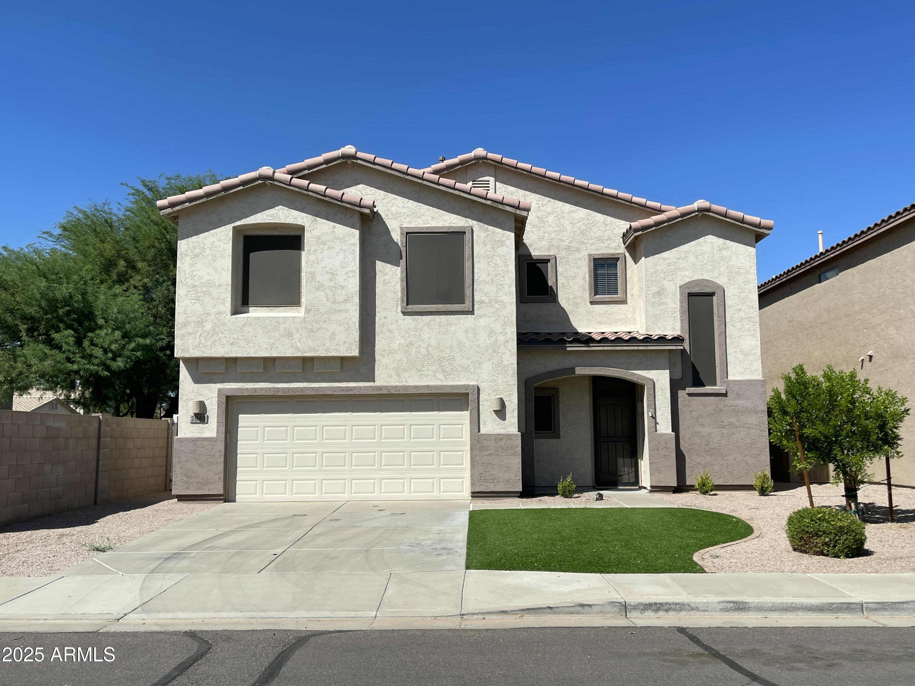 2640 East Indian Wells Place Chandler, AZ 85249 - Photo 1 of 40 a front view of a house with a garden and garage