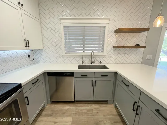a kitchen with a sink cabinets and window
