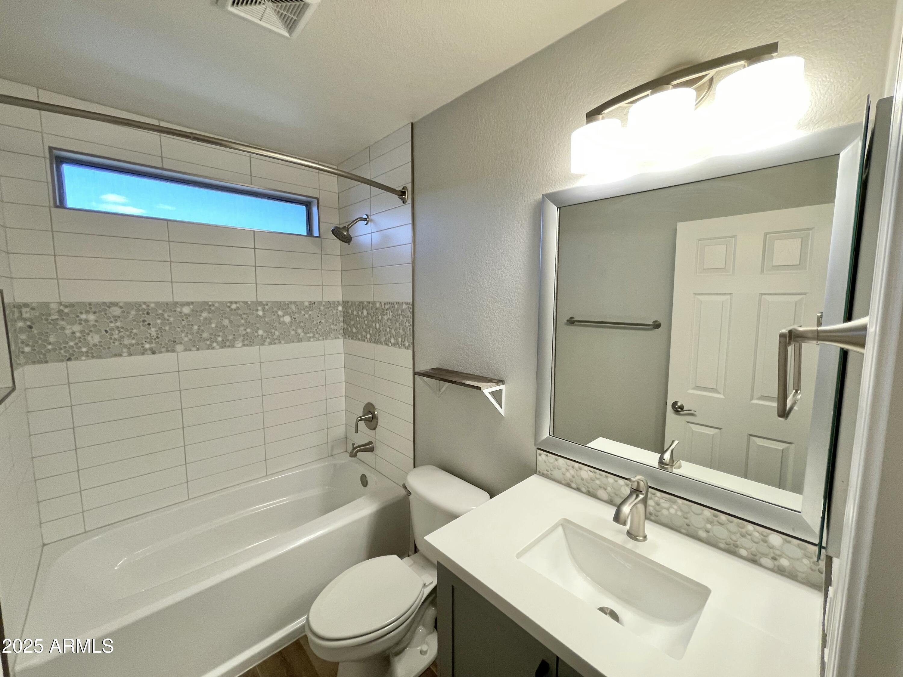 2640 East Indian Wells Place Chandler, AZ 85249 - Photo 21 of 40 a bathroom with a sink toilet and shower