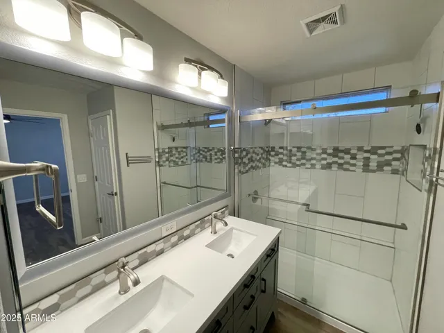 a bathroom with a sink and mirror