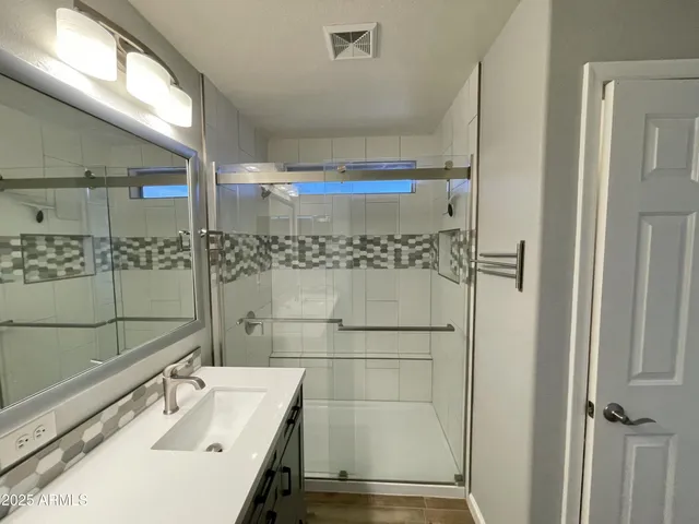 a bathroom with a sink and a shower