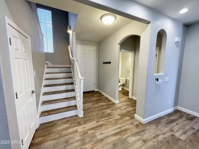 a view of entryway with wooden floor and stairs