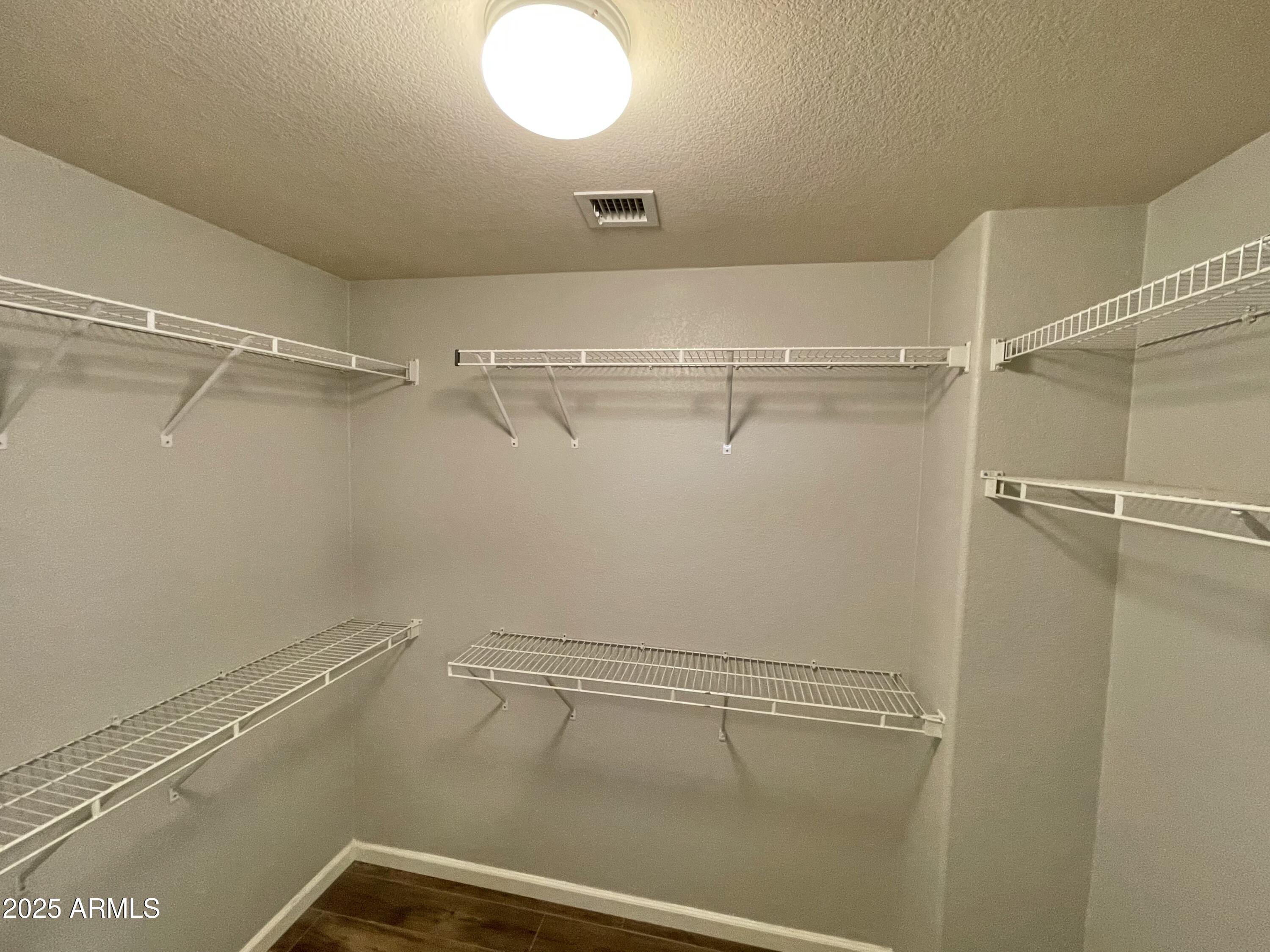 2640 East Indian Wells Place Chandler, AZ 85249 - Photo 31 of 40 a view of a room with racks on the wall