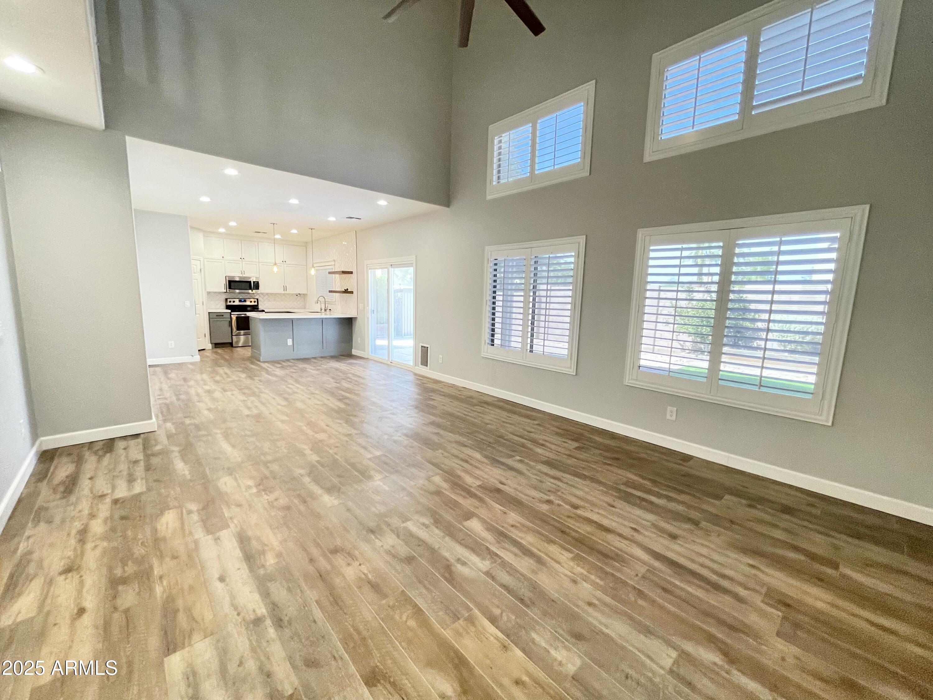 2640 East Indian Wells Place Chandler, AZ 85249 - Photo 8 of 40 a view of an empty room with window and kitchen view