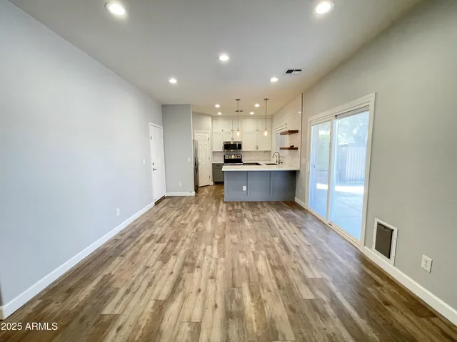 a view of kitchen with sink and refrigerator