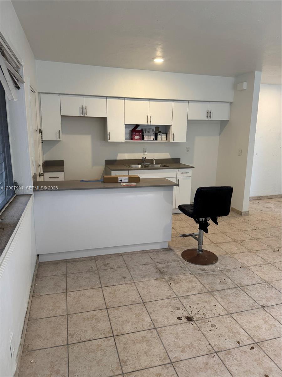 a kitchen with stainless steel appliances granite countertop a sink and a stove