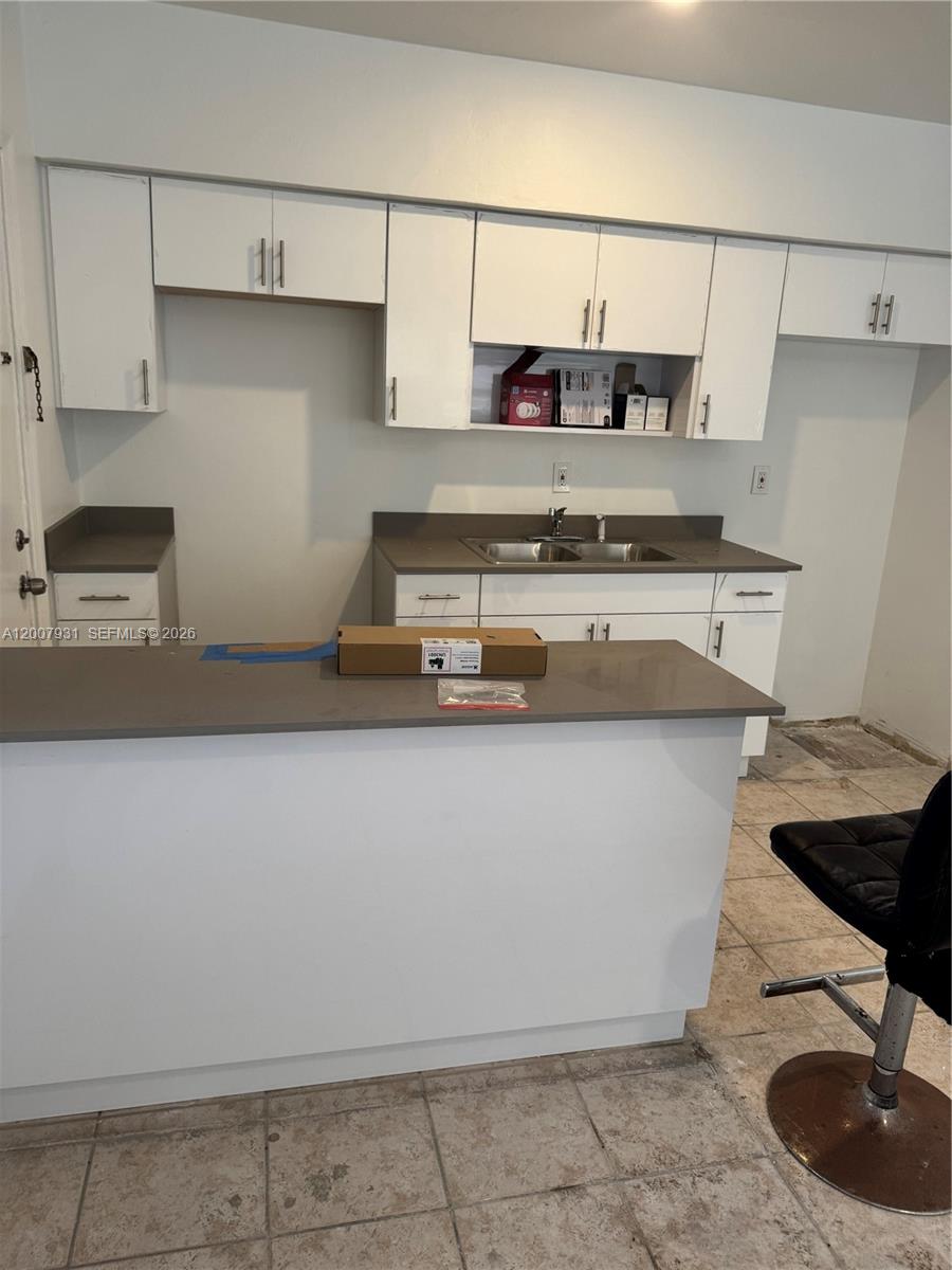 7300 Harding Avenue, Unit 21 Miami Beach, FL 33141 - Photo 2 of 6 a kitchen with a stove and a refrigerator