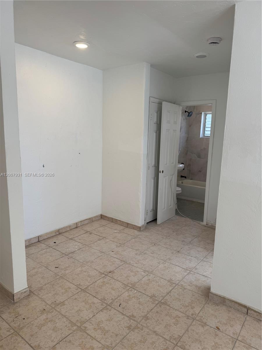 7300 Harding Avenue, Unit 21 Miami Beach, FL 33141 - Photo 3 of 6 an empty room with a bathroom