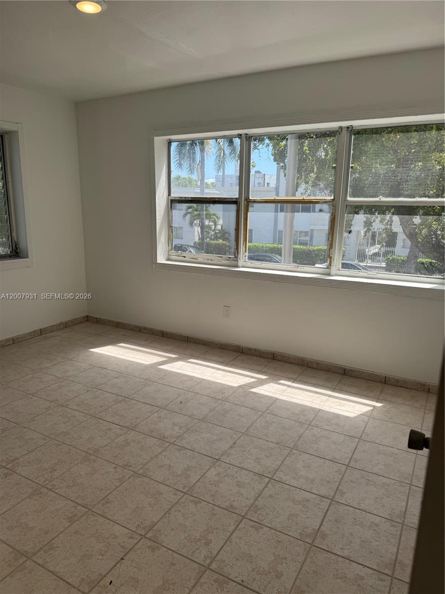 7300 Harding Avenue, Unit 21 Miami Beach, FL 33141 - Photo 4 of 6 an empty room with windows