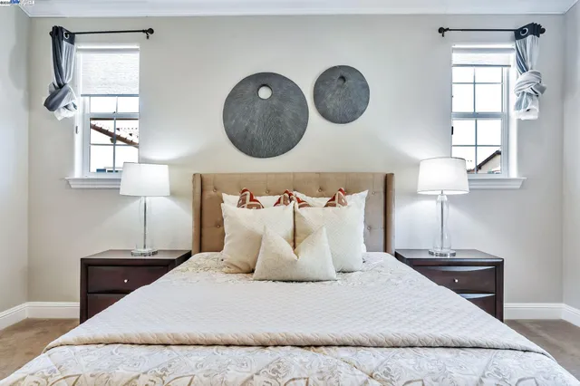 a bedroom with a bed and a lamp