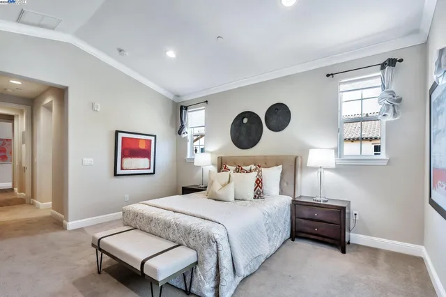 a bedroom with a bed and a painting on the wall