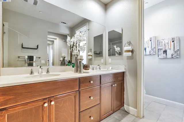 a bathroom with a double vanity sink and a mirror