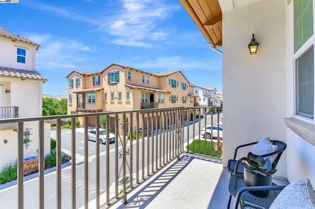 a view of a houses with a bench in a balcony