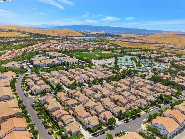 an aerial view of residential houses with city view