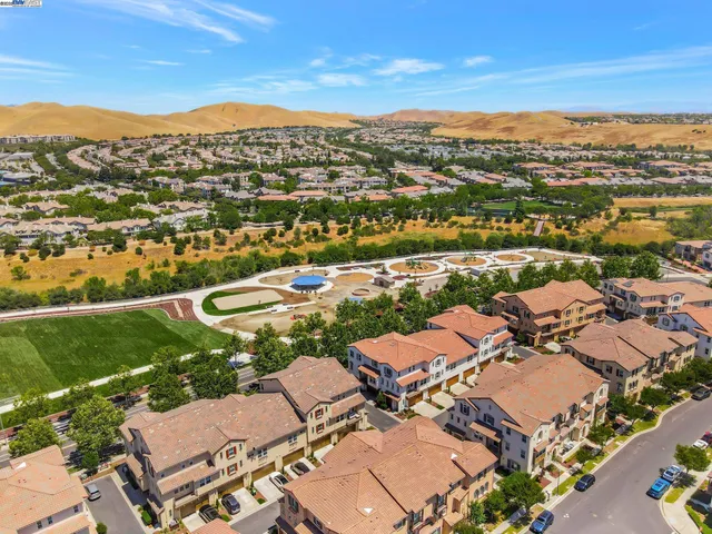 an aerial view of residential houses with outdoor space