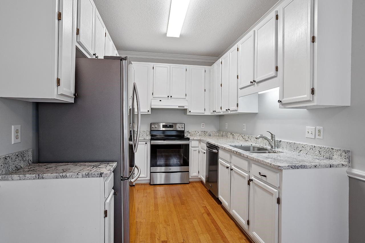 3715 Carnegie Lane Raleigh, NC 27612 - Photo 14 of 37 Cheerful Kitchen with White Cabinets