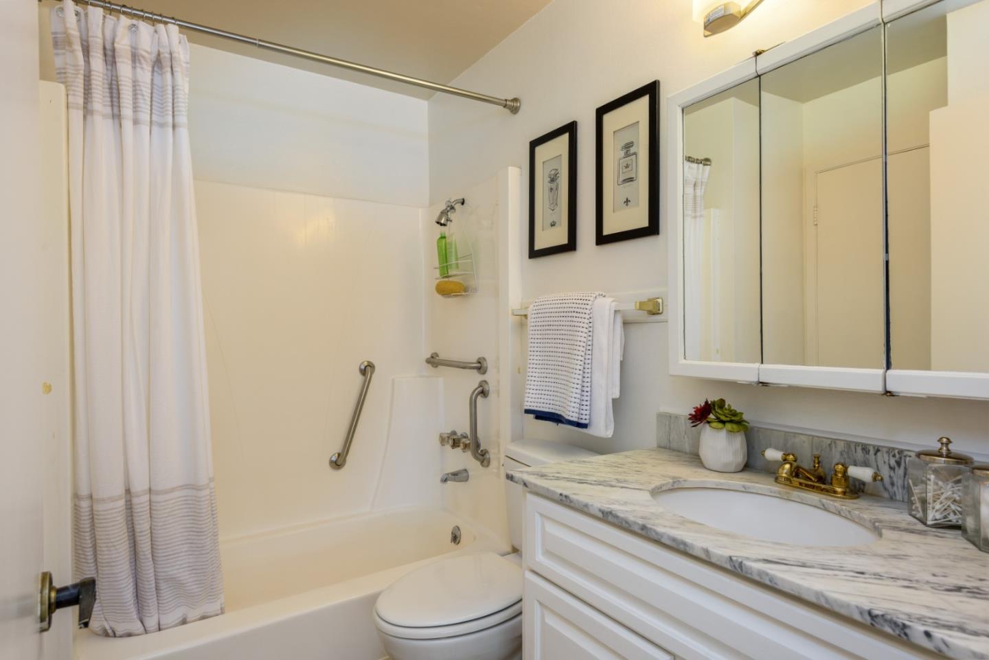 1029 Suzanne Court Half Moon Bay, CA 94019 - Photo 13 of 25 a bathroom with a granite countertop sink a toilet and shower