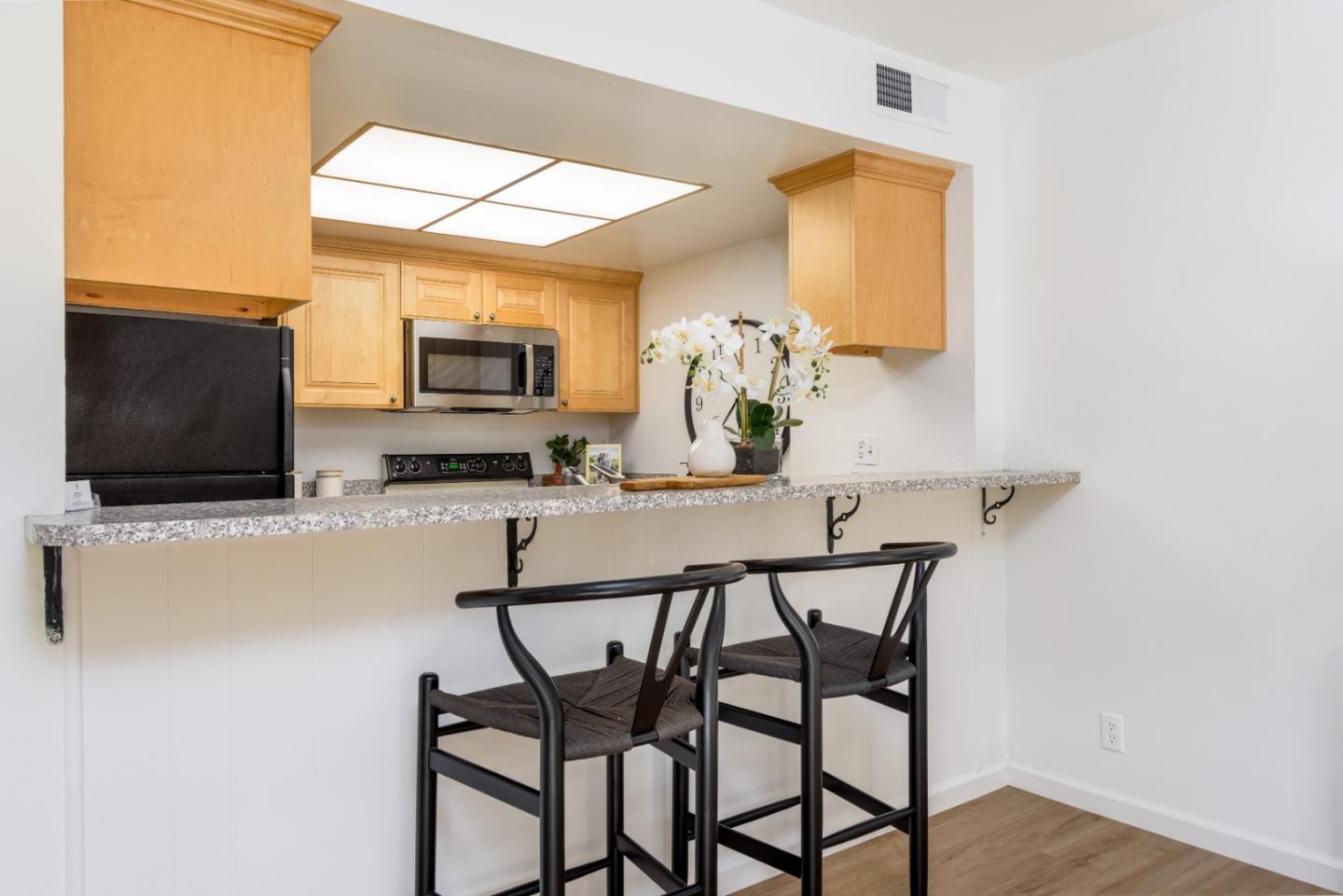 1029 Suzanne Court Half Moon Bay, CA 94019 - Photo 7 of 25 a dining room with furniture and a flat screen tv