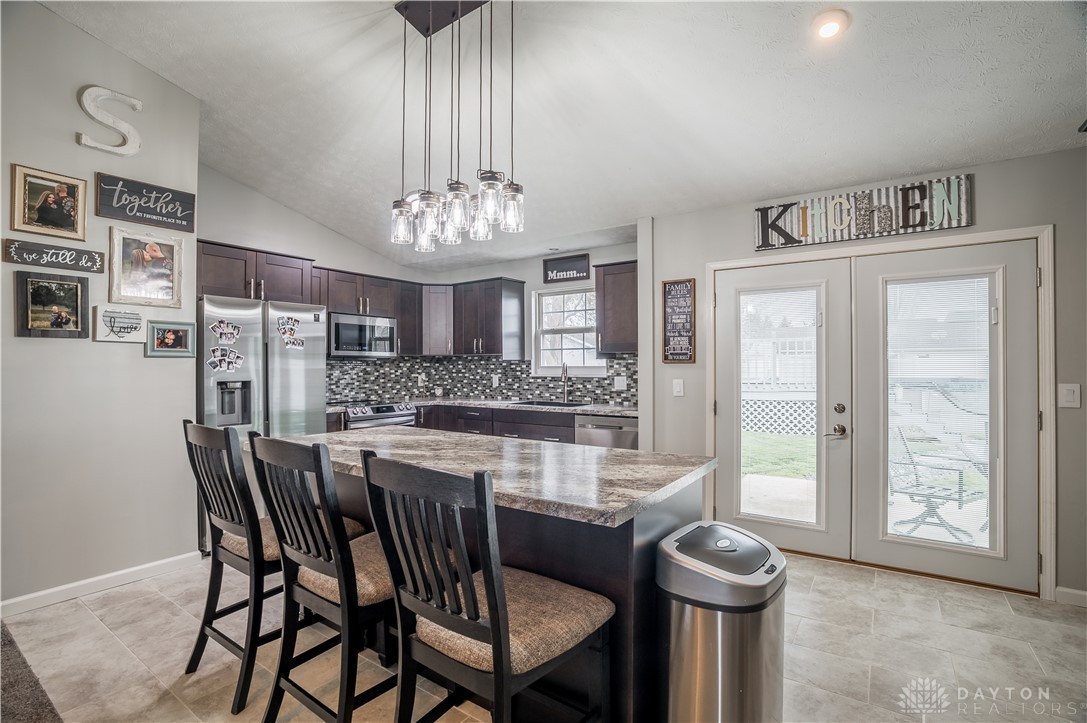 1442 Langdon Road Sidney, OH 45365 - Photo 8 of 34 This bright kitchen features modern appliances, a practical island, and direct access to outdoor living.