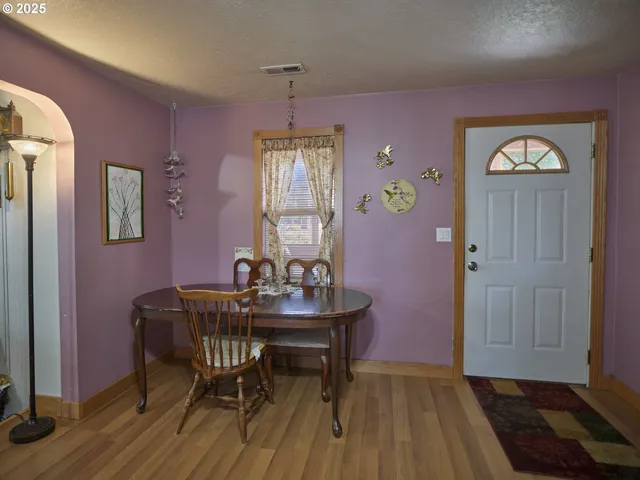 a living room with furniture a lamp and a window